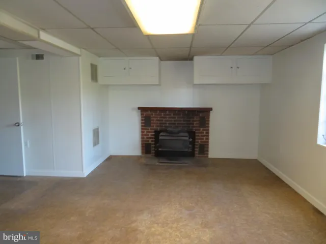 a view of an empty room with a fireplace