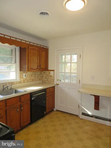 a view of a kitchen with a sink and cabinets