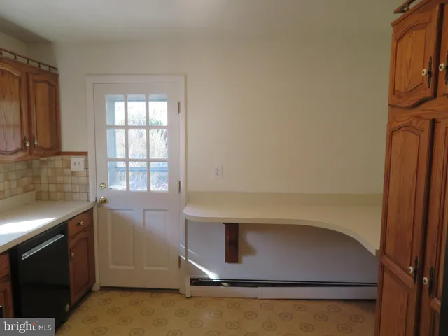 a view of an empty room with a fireplace