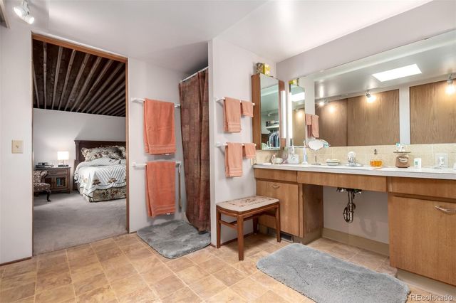 a view of a bathroom with sink shower and mirror
