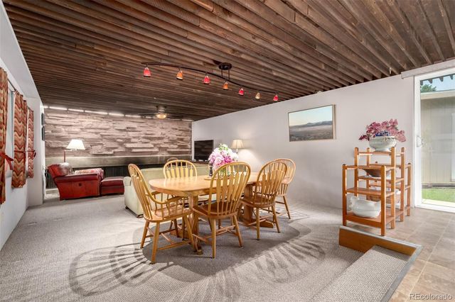 a dining room with furniture a rug and a chandelier