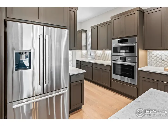 a kitchen with stainless steel appliances granite countertop a refrigerator stove and oven
