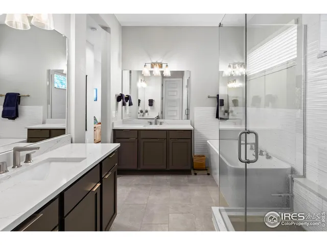 a bathroom with a sink a vanity a mirror and a shower
