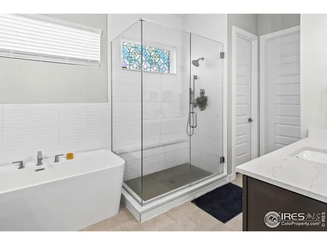 a bathroom with a tub a sink and a shower