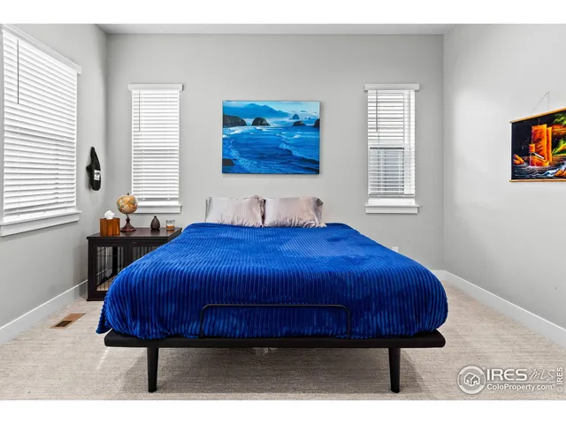 a bed sitting in a bedroom next to a window