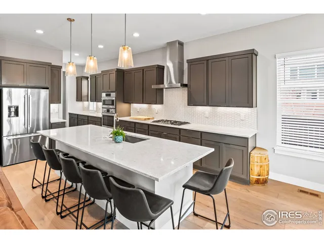 a kitchen with a dining table cabinets and refrigerator