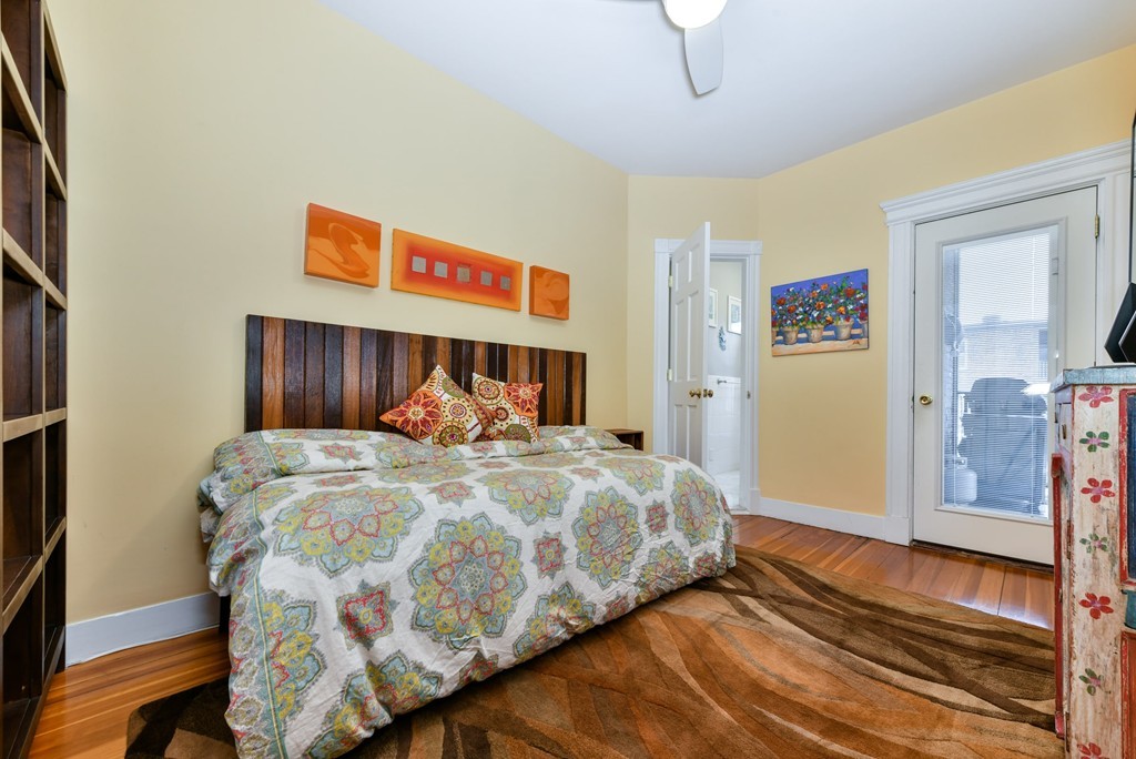 17 Strathmore Road, Unit 3 Brookline, MA 02445 - Photo 17 of 24 a bedroom with a bed and wooden floor