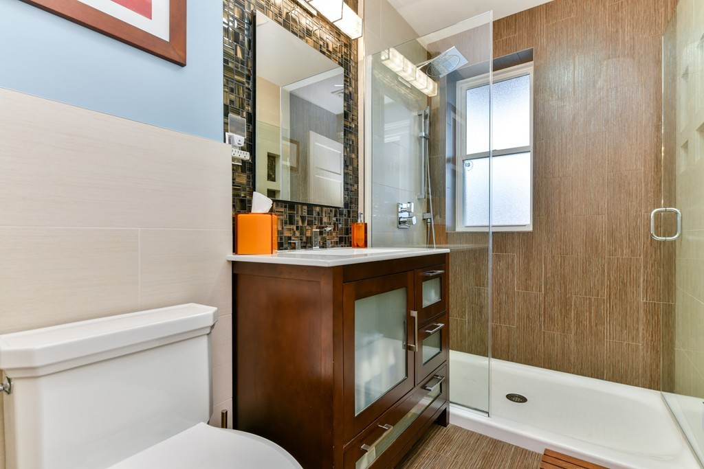 17 Strathmore Road, Unit 3 Brookline, MA 02445 - Photo 18 of 24 a bathroom with a toilet a sink and shower