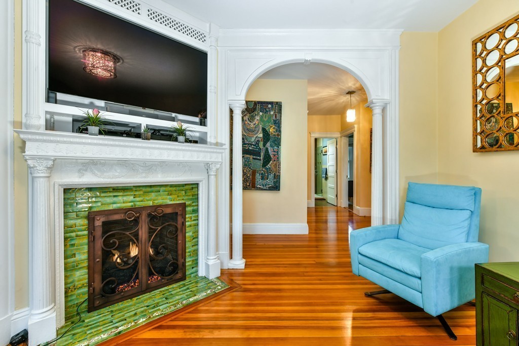 17 Strathmore Road, Unit 3 Brookline, MA 02445 - Photo 3 of 24 a living room with a fireplace and a flat screen tv