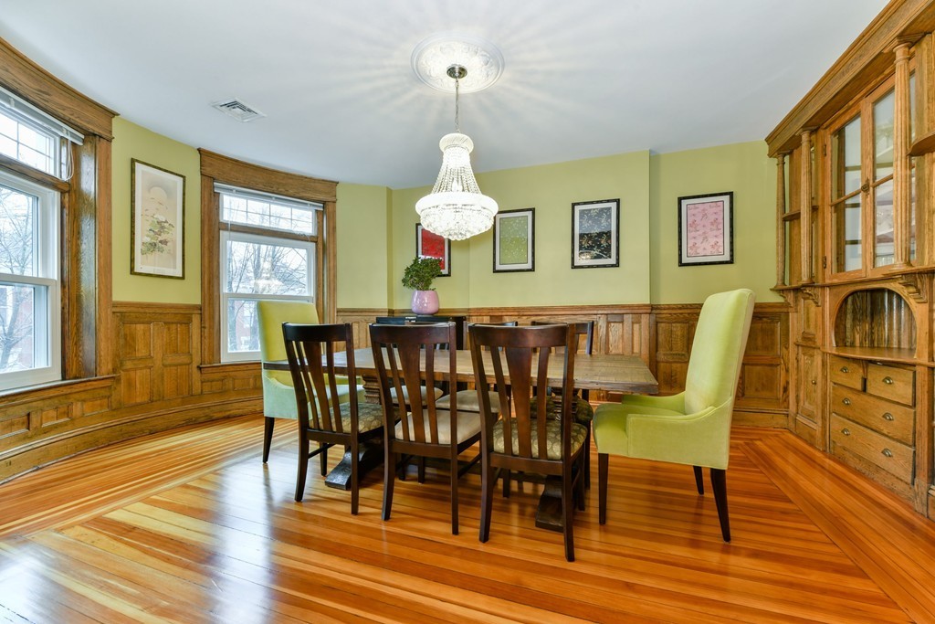 17 Strathmore Road, Unit 3 Brookline, MA 02445 - Photo 6 of 24 a dining room with wooden floor a chandelier a wooden table and chairs