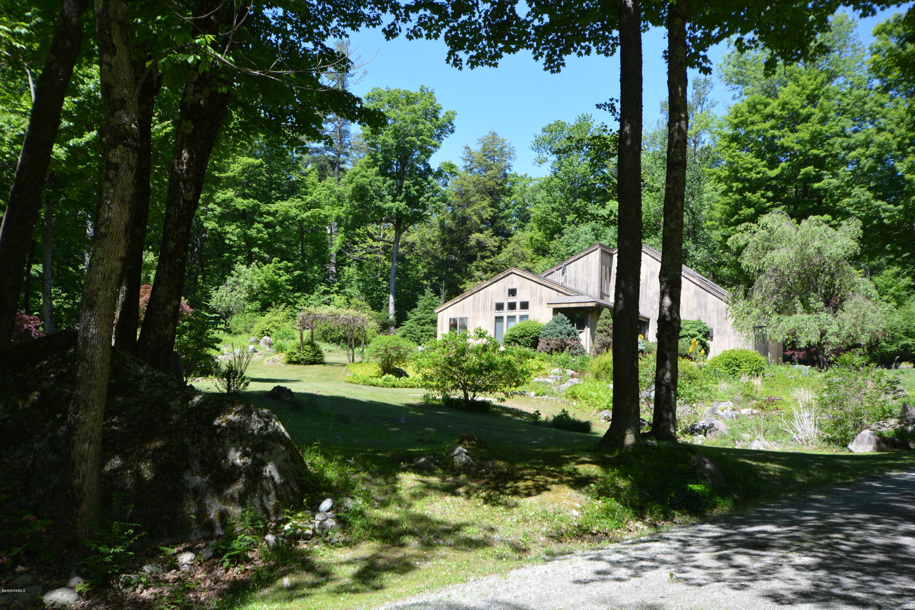 1304 West Center Road Otis, MA 01253 - Photo 2 of 28 a view of a garden with a tree
