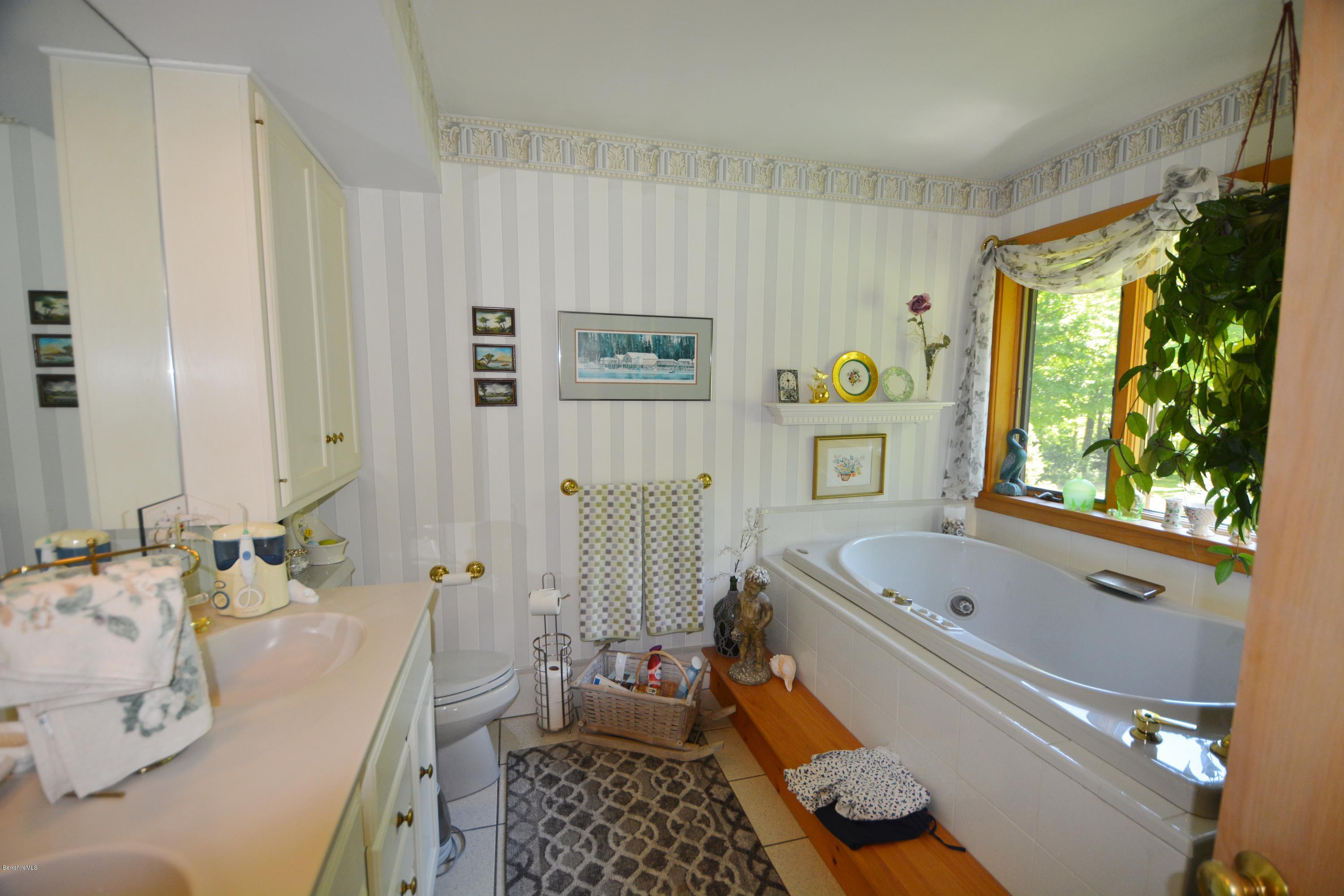 1304 West Center Road Otis, MA 01253 - Photo 11 of 28 a bath room with a bath tub and a shower