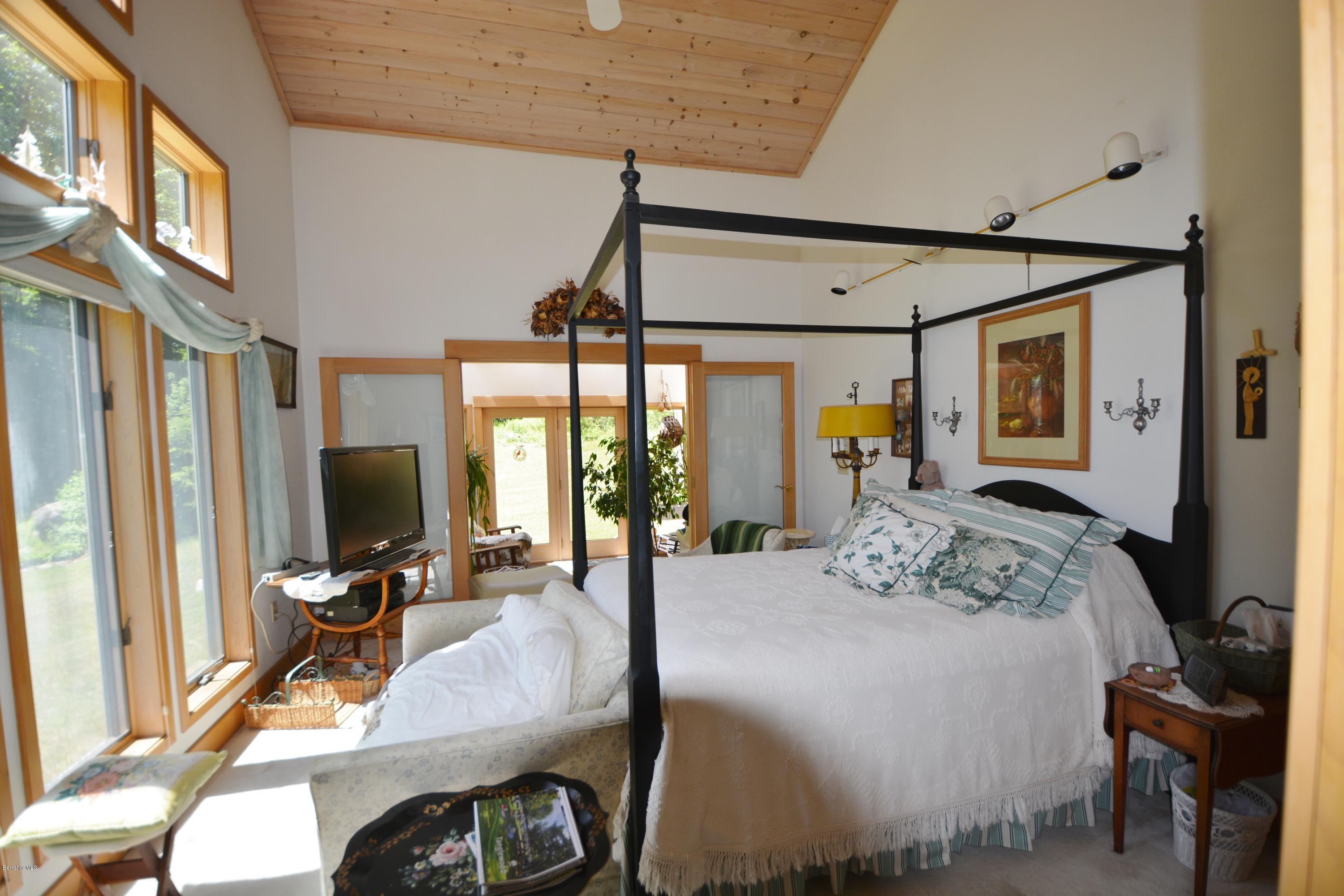 1304 West Center Road Otis, MA 01253 - Photo 12 of 28 a bedroom with a bed window and a flat screen tv