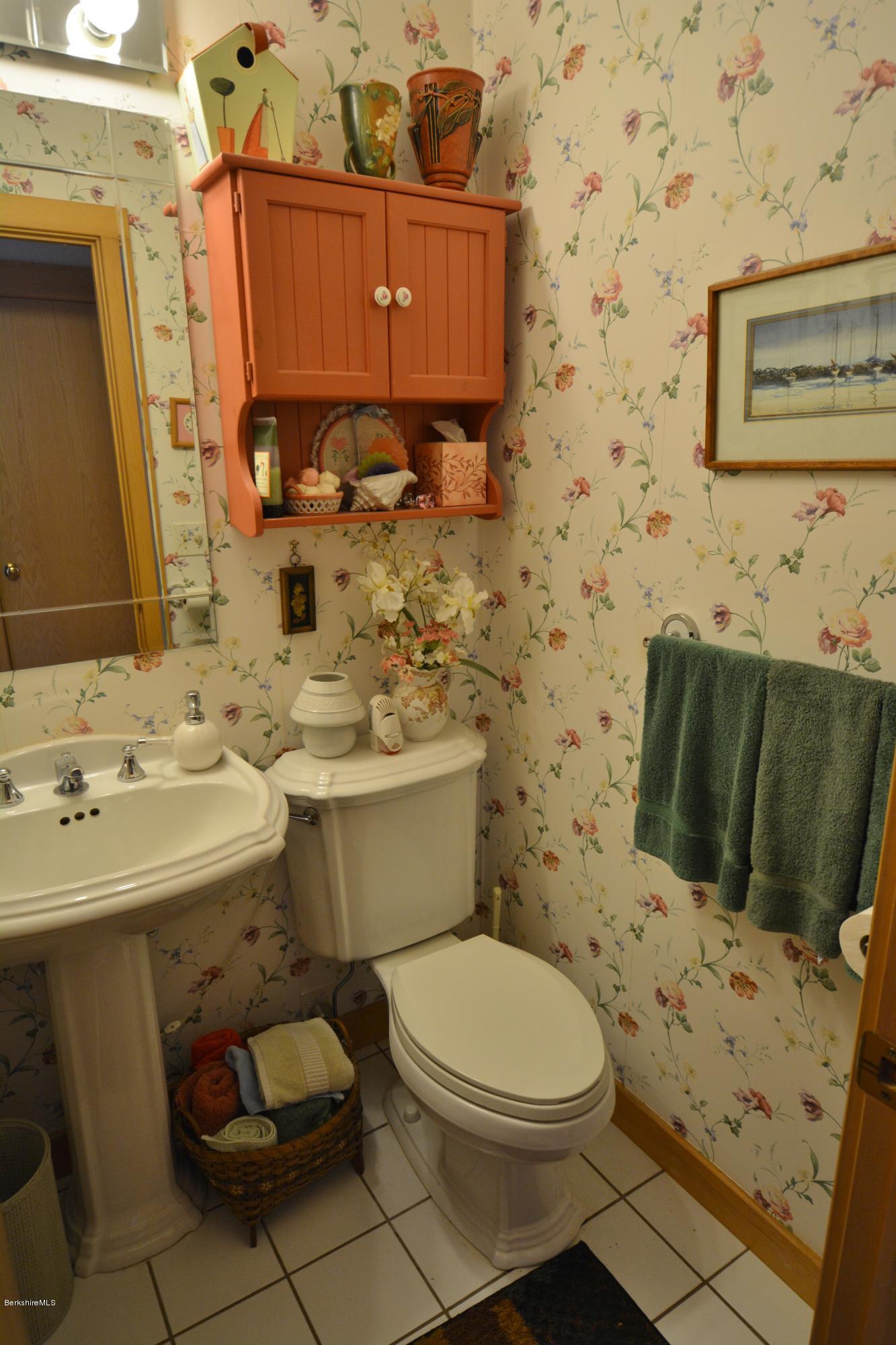 1304 West Center Road Otis, MA 01253 - Photo 13 of 28 a bathroom with a sink toilet and mirror