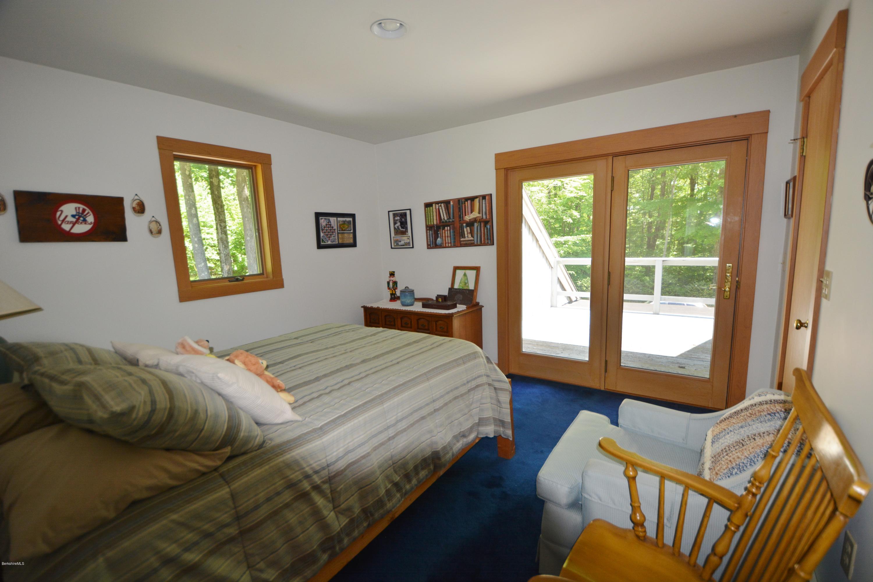 1304 West Center Road Otis, MA 01253 - Photo 19 of 28 a bedroom with a bed and wooden floor