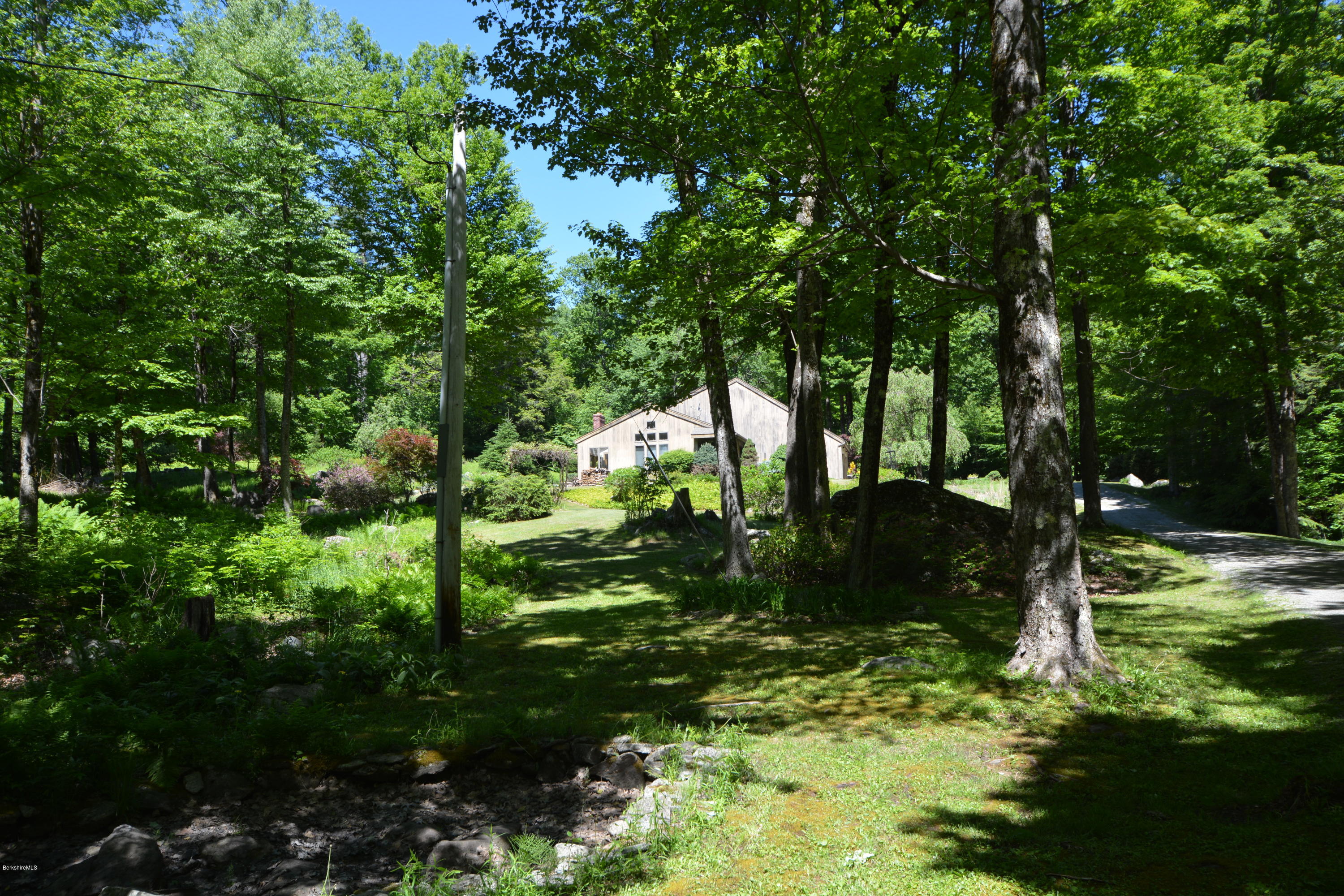 1304 West Center Road Otis, MA 01253 - Photo 26 of 28 a backyard of a house with lots of green space