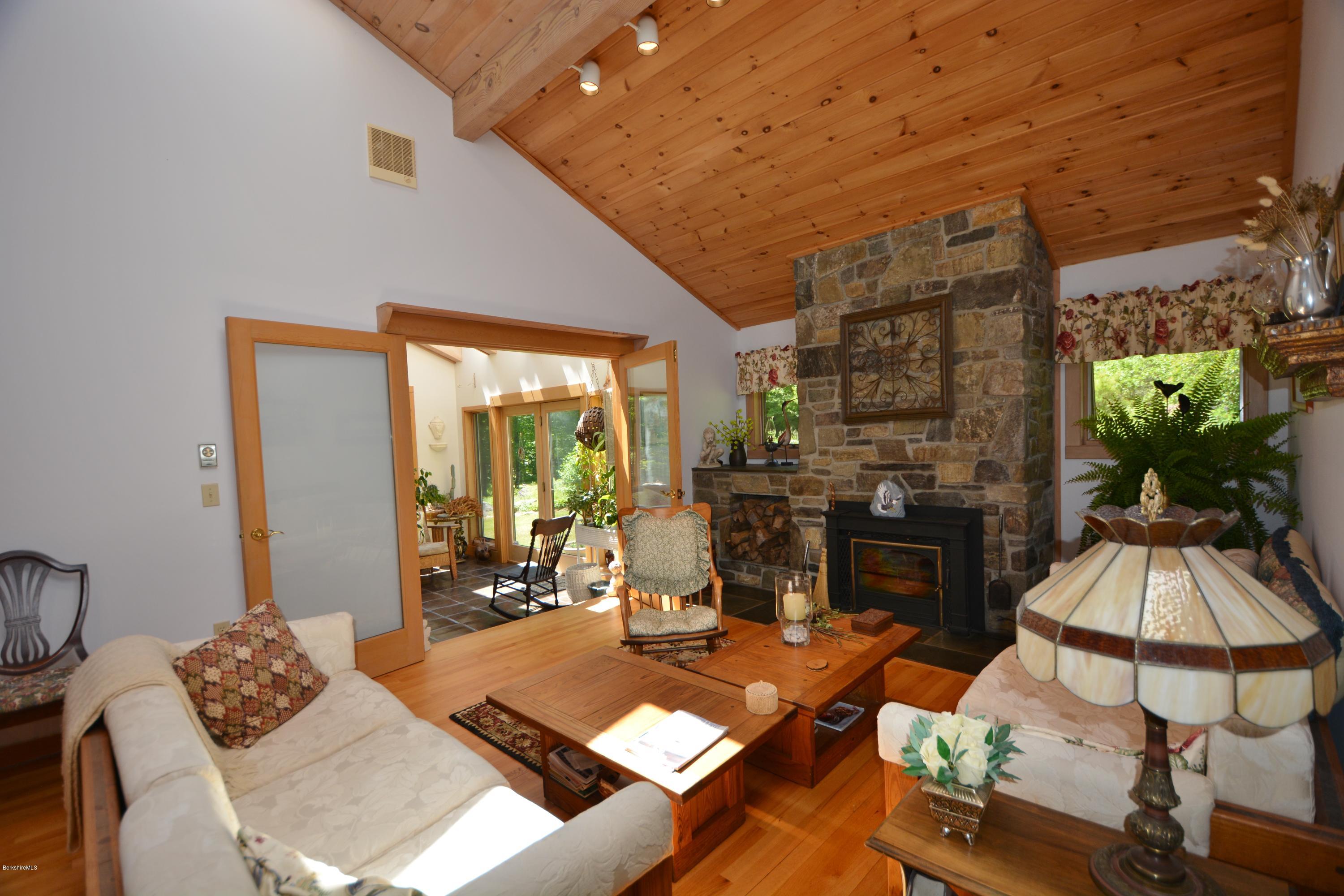 1304 West Center Road Otis, MA 01253 - Photo 4 of 28 a living room with furniture and a floor to ceiling window