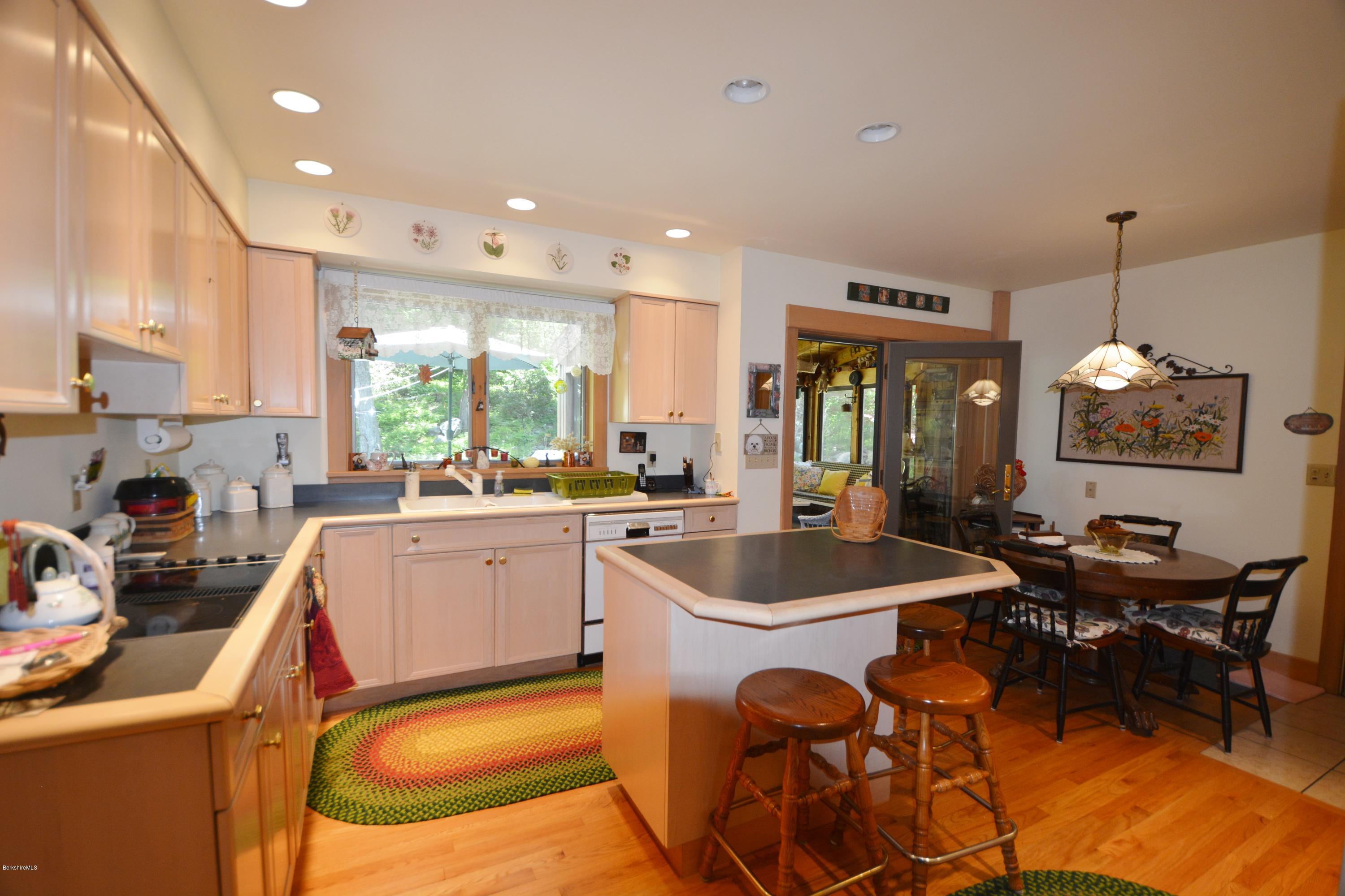 1304 West Center Road Otis, MA 01253 - Photo 8 of 28 a kitchen with sink refrigerator dining table and chairs