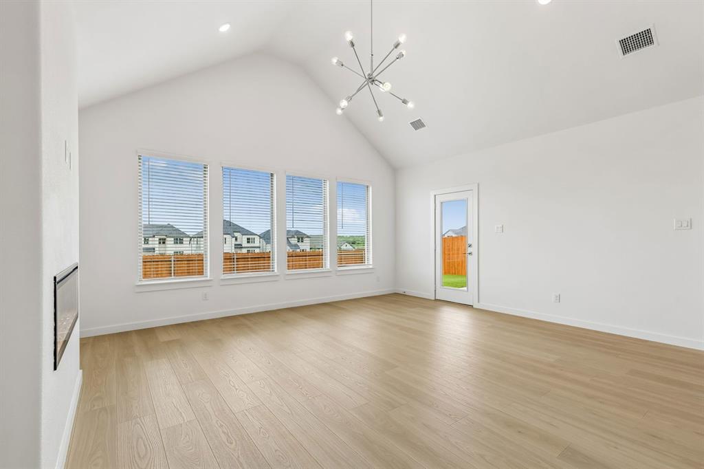 1429 Companero Street Haslet, TX 76052 - Photo 13 of 35 an empty room with wooden floor and windows