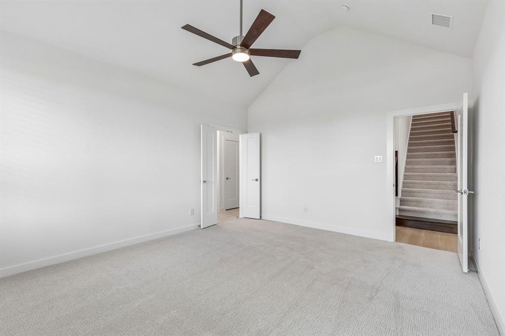1429 Companero Street Haslet, TX 76052 - Photo 18 of 35 a view of a livingroom with a ceiling fan and wooden floor