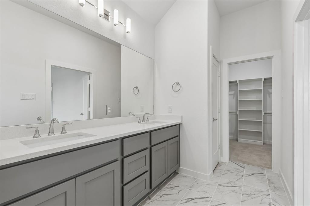 1429 Companero Street Haslet, TX 76052 - Photo 22 of 35 a spacious bathroom with a double vanity sink a mirror and a
