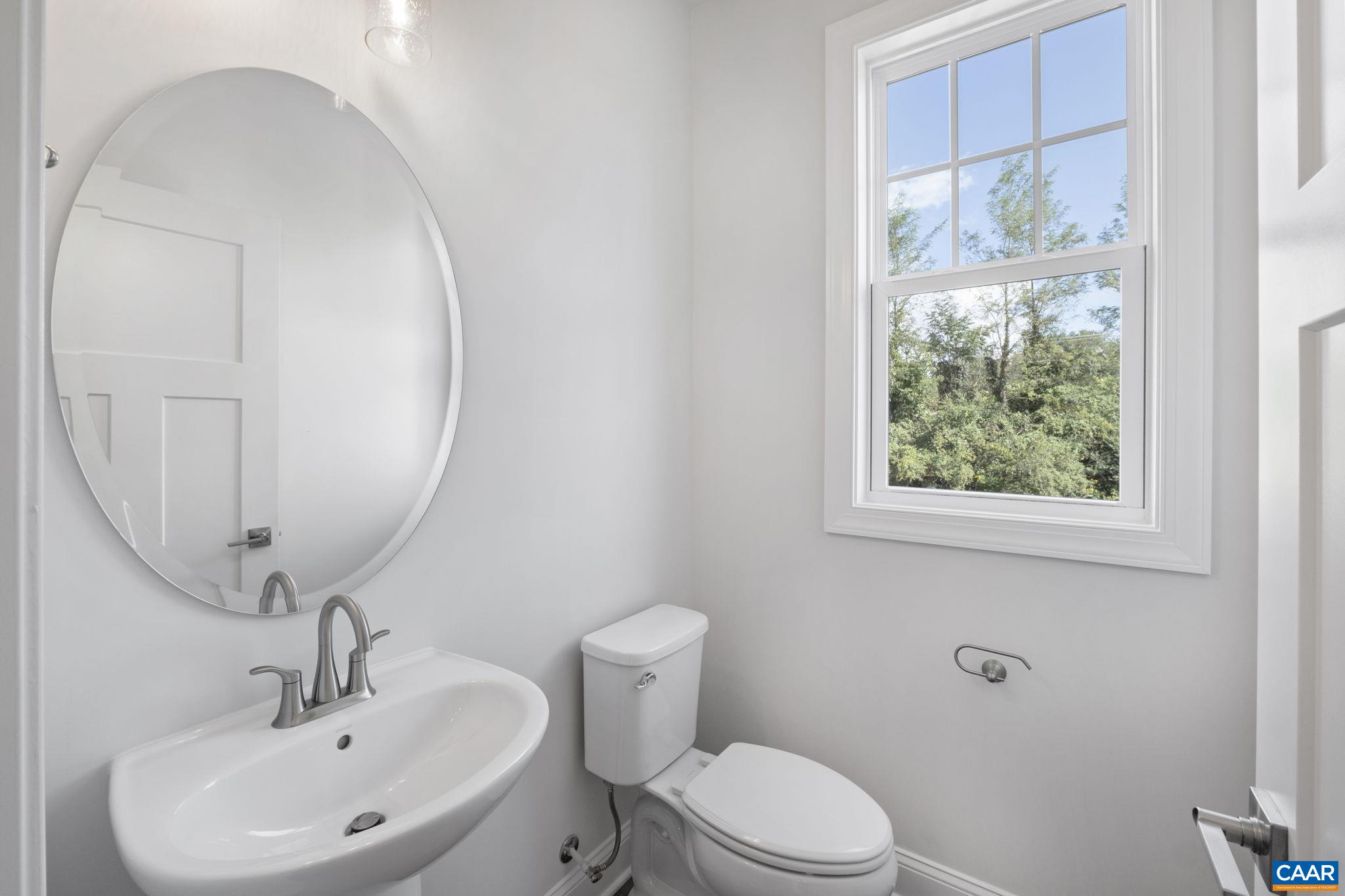 108 Park Ridge Drive Crozet, VA 22932 - Photo 25 of 54 a bathroom with a toilet a sink a mirror and a window