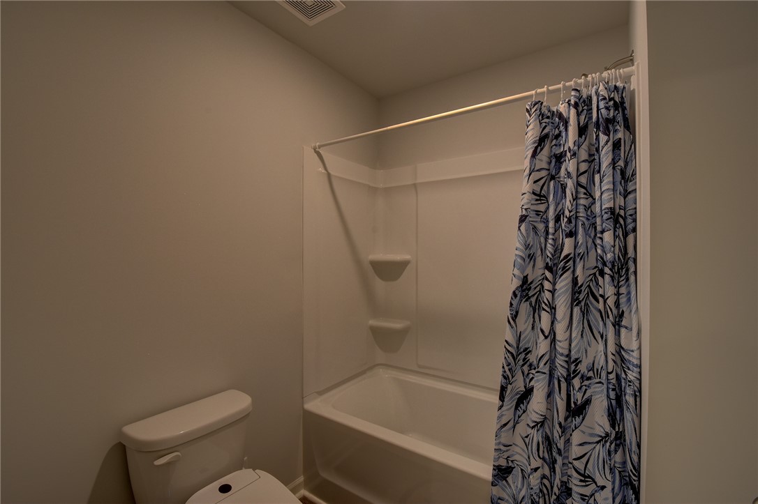 220 Clinkscales Road Anderson, SC 29624 - Photo 22 of 33 A clean shower and tub combination stands ready in this functional bathroom.