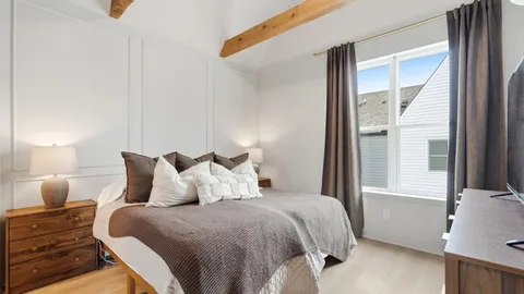 a bedroom with a bed and window