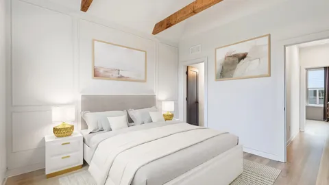 a bedroom with bed and wall painting