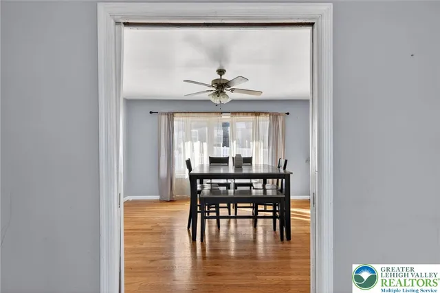 a dining room with furniture a rug and a large window