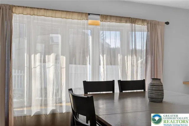 a dining room with furniture and window