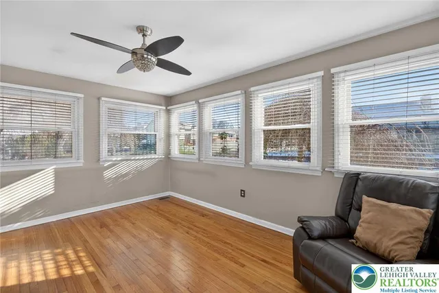a kitchen with stainless steel appliances granite countertop white cabinets and a window