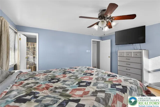 a bedroom with a bed a table and a chandelier