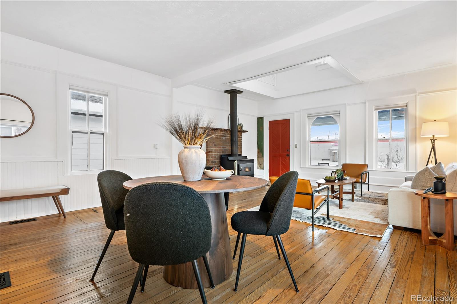 4743 Tejon Street Denver, CO 80211 - Photo 11 of 30 a dining room with furniture wooden floor a rug and a chandelier