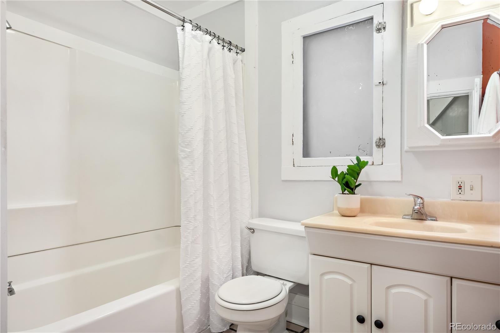 4743 Tejon Street Denver, CO 80211 - Photo 18 of 30 a bathroom with a sink toilet and a mirror
