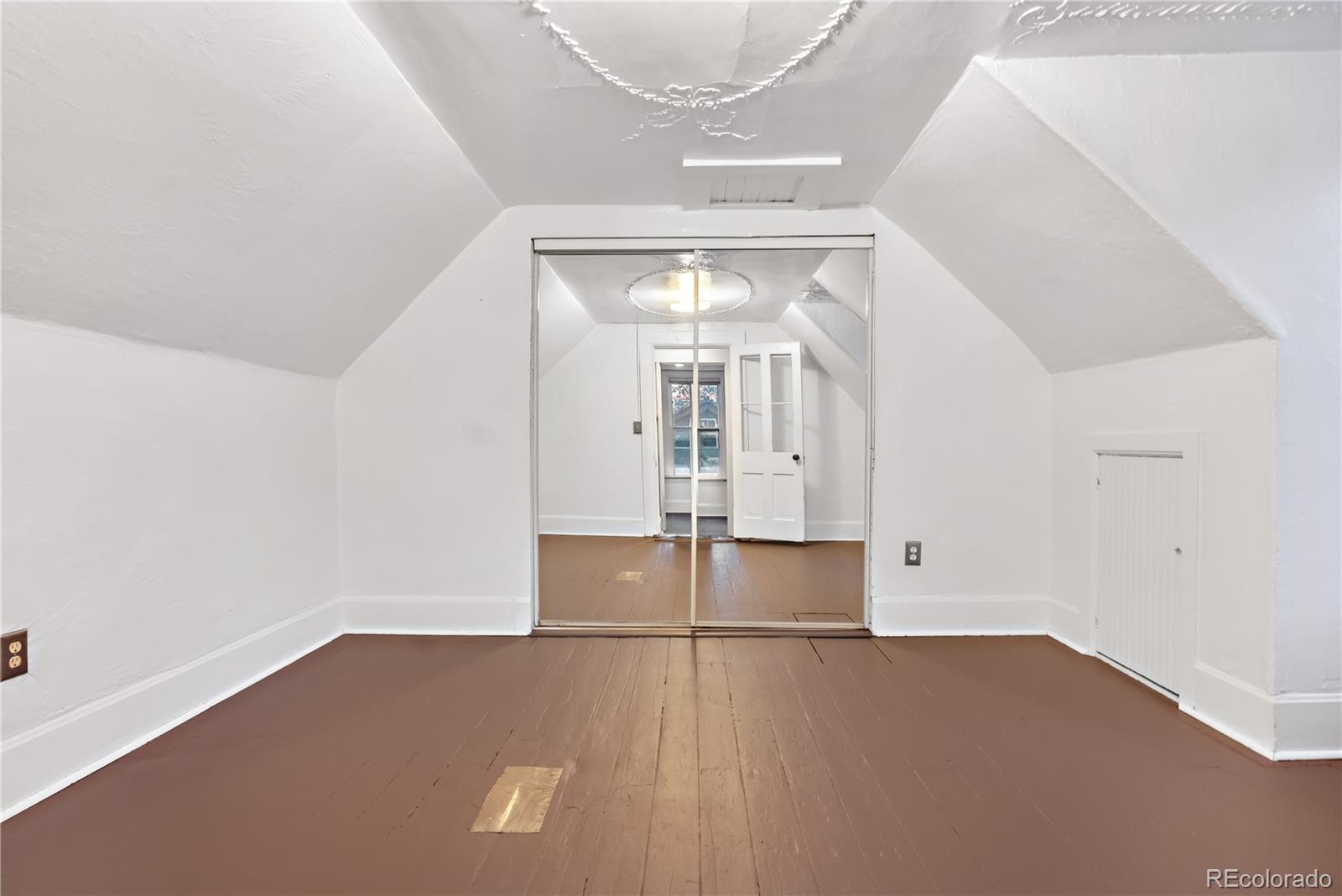 4743 Tejon Street Denver, CO 80211 - Photo 24 of 30 an empty room with wooden floor and windows