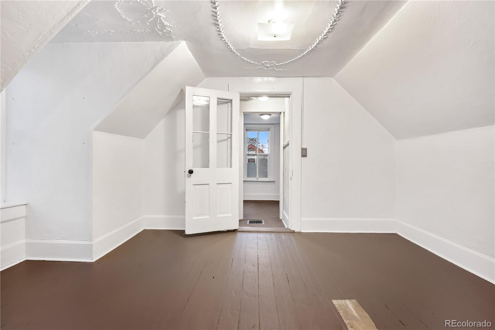4743 Tejon Street Denver, CO 80211 - Photo 26 of 30 an empty room with wooden floor and windows