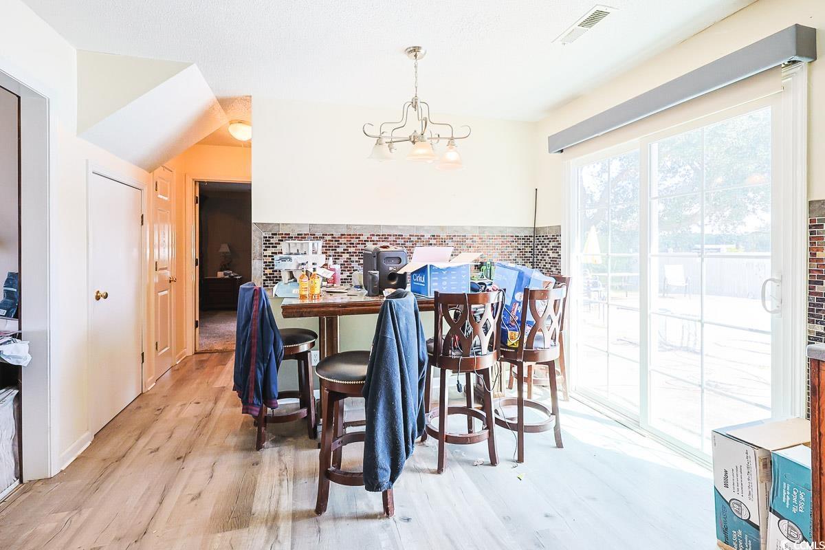 210 Rail Street Longs, SC 29568 - Photo 13 of 32 Dining space featuring light wood-type flooring and a chandelier