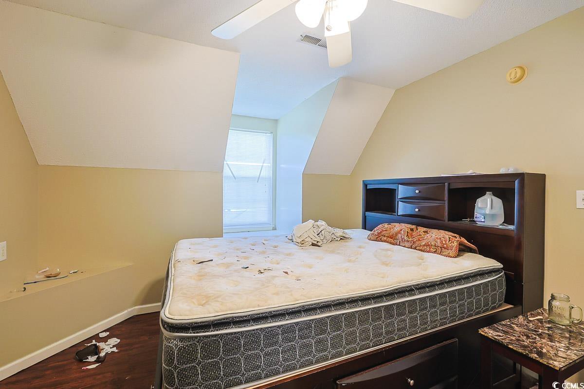 210 Rail Street Longs, SC 29568 - Photo 21 of 32 Bedroom with dark wood finished floors, ceiling fan, and vaulted ceiling