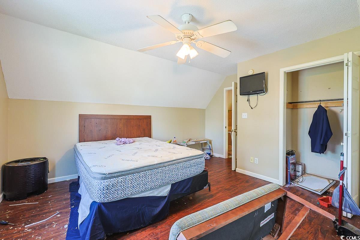 210 Rail Street Longs, SC 29568 - Photo 25 of 32 Bedroom with lofted ceiling, dark wood-style floors, a ceiling fan, and a closet