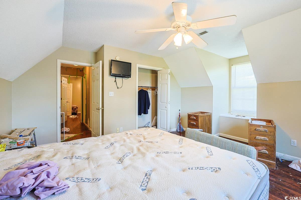 210 Rail Street Longs, SC 29568 - Photo 26 of 32 Bedroom featuring lofted ceiling, dark wood-style floors, a closet, ceiling fan, and a textured ceiling