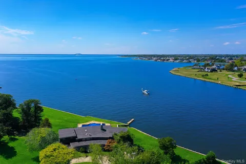 an aerial view of a house with a lake view