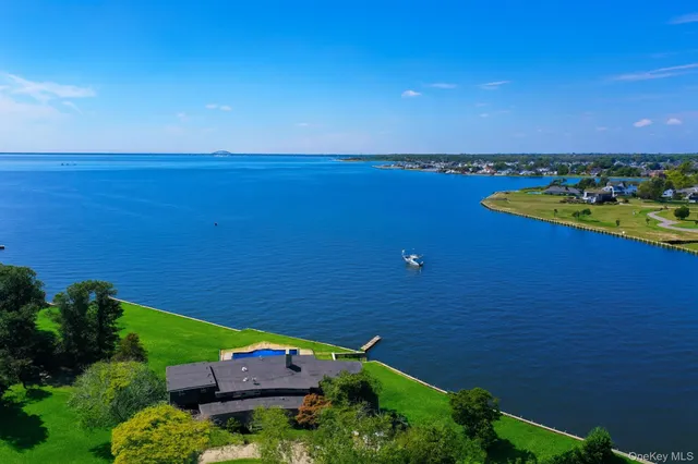 an aerial view of a house with a lake view