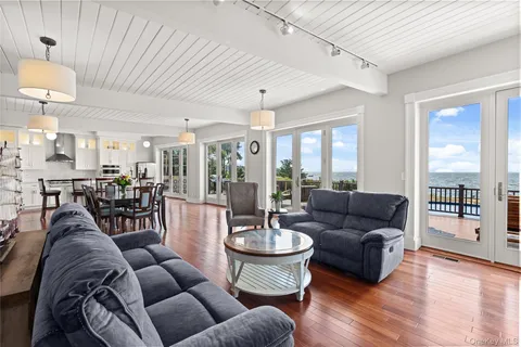a living room with furniture dining table and a large window
