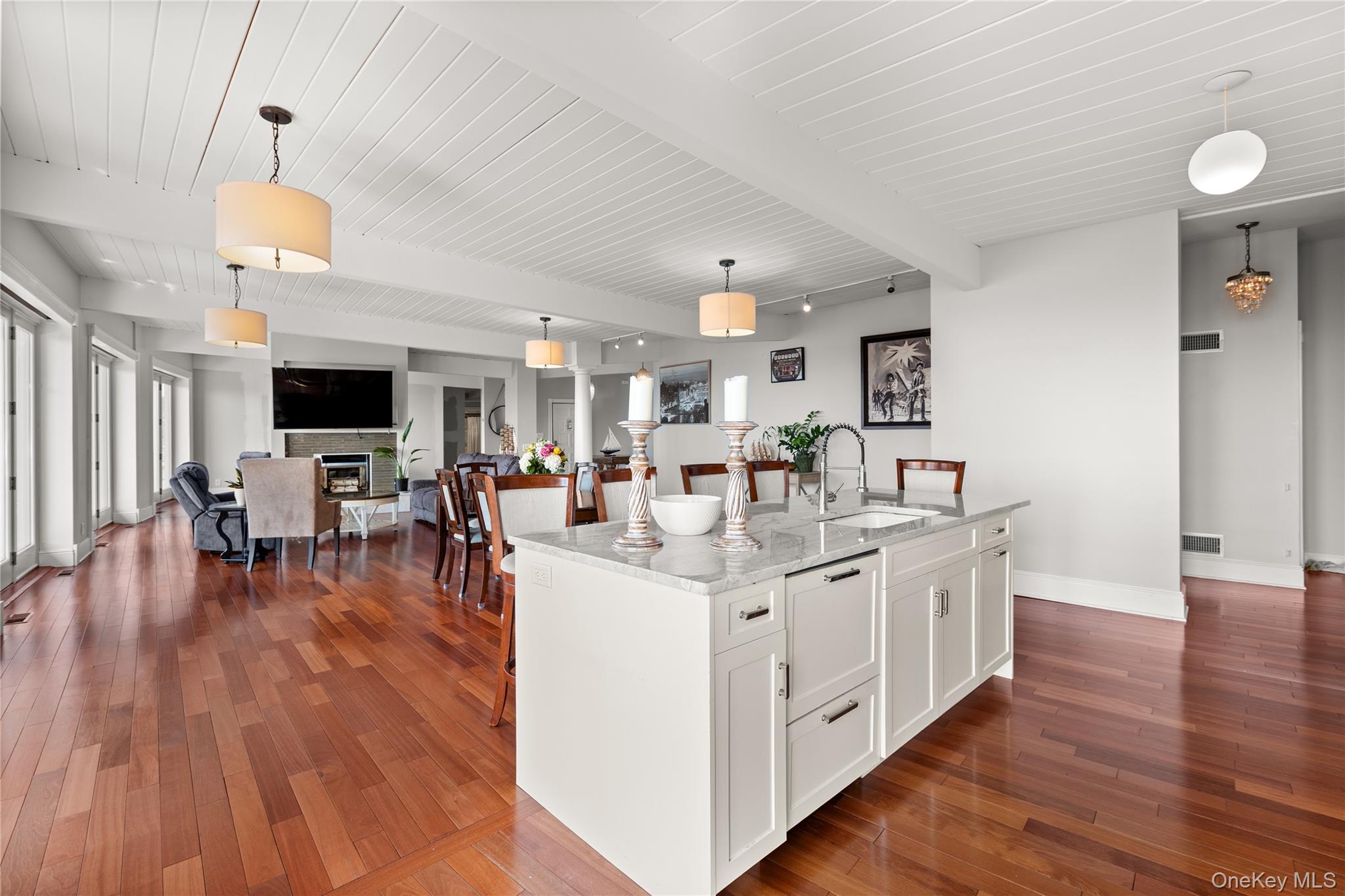 10 Great Cove Lane Islip, NY 11751 - Photo 31 of 31 a kitchen with stainless steel appliances a stove top oven a sink a dining table and chairs with wooden floor