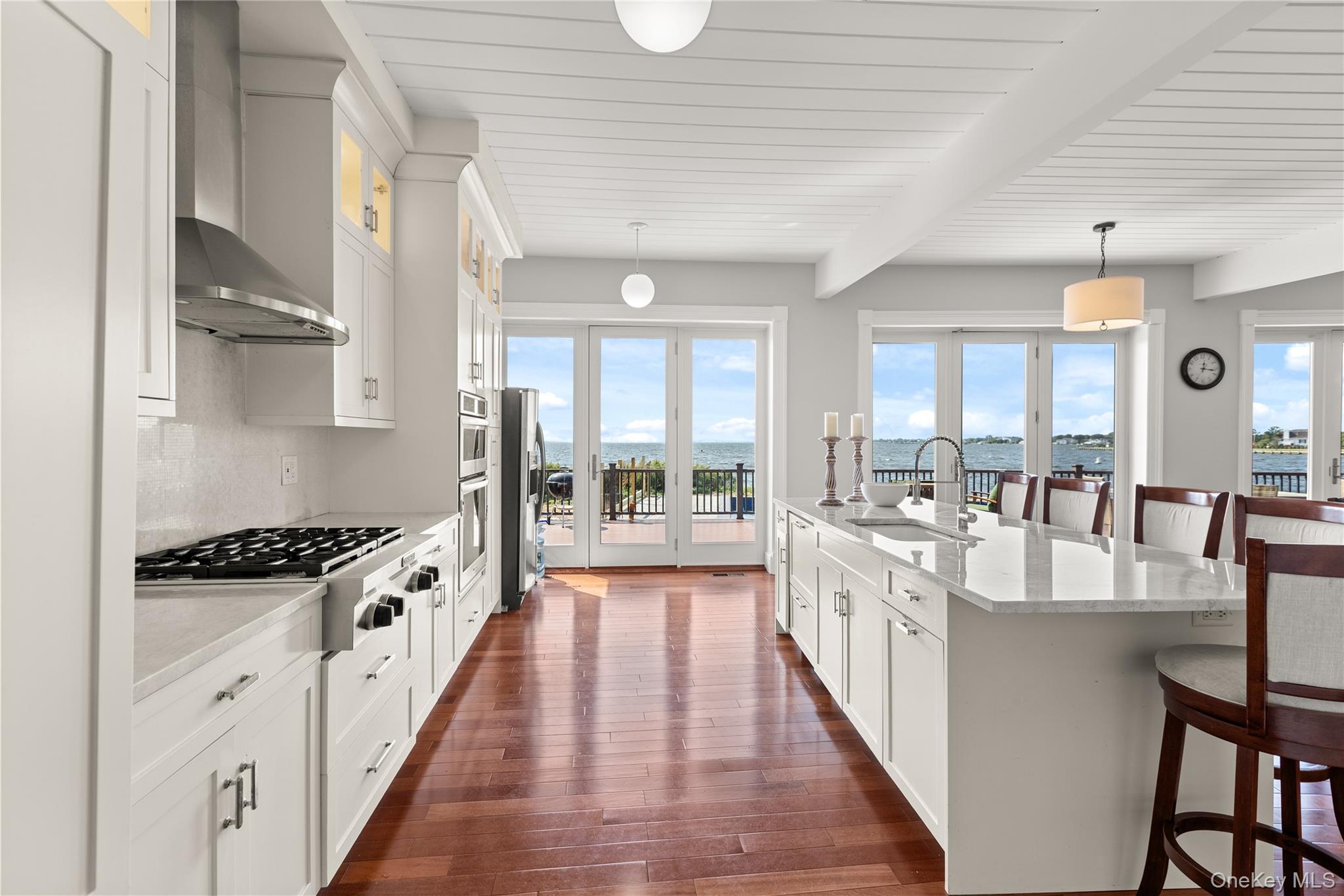 10 Great Cove Lane Islip, NY 11751 - Photo 16 of 31 a large kitchen with stainless steel appliances granite countertop a lot of counter space and wooden floors
