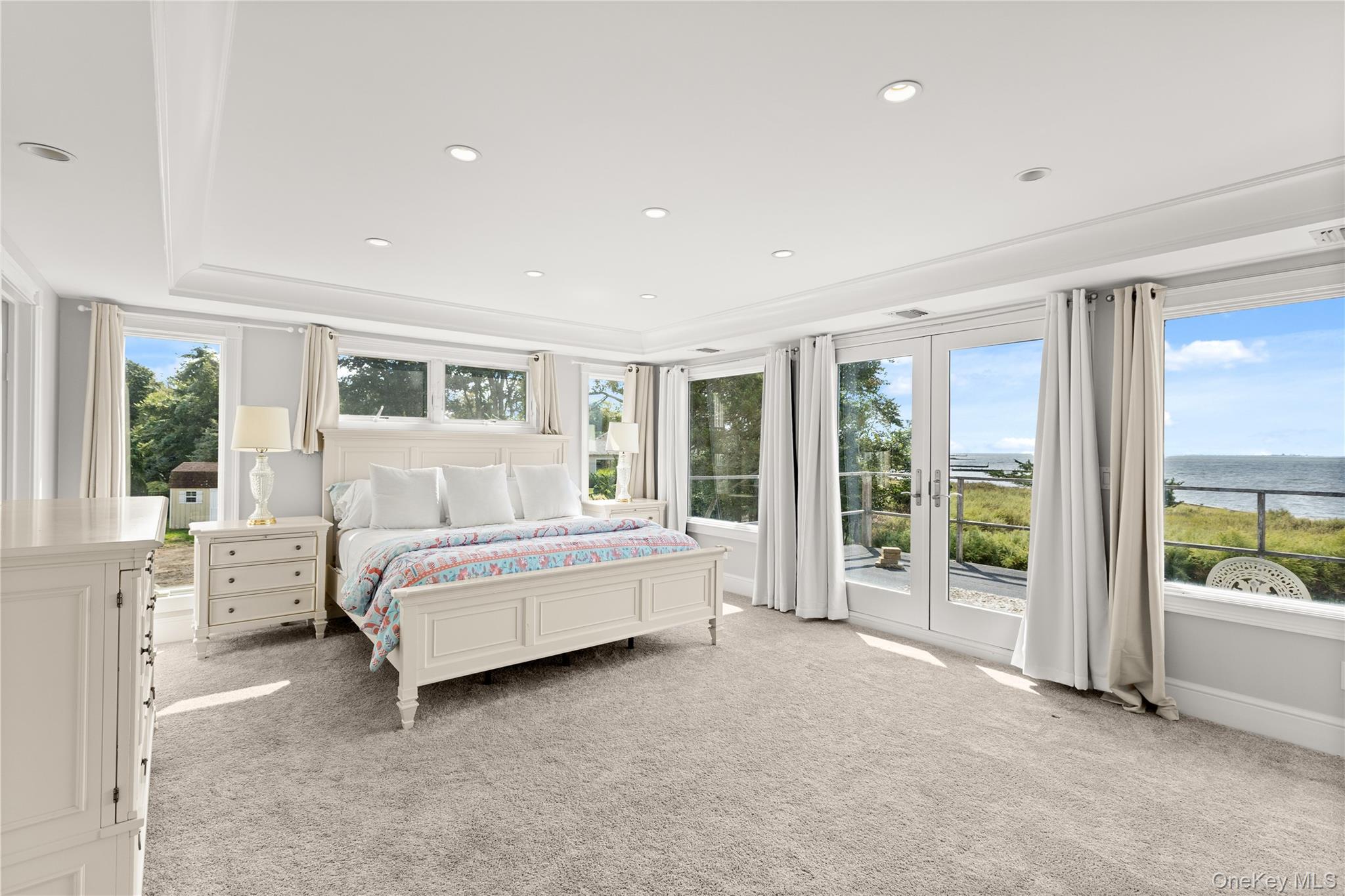 10 Great Cove Lane Islip, NY 11751 - Photo 18 of 31 a spacious bedroom with a large bed and a couch next to a window