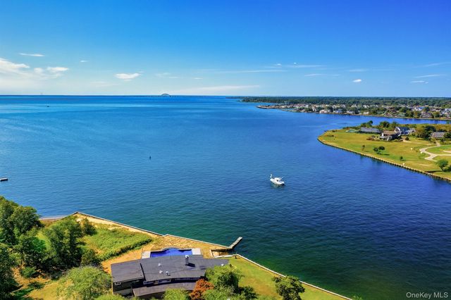 an aerial view of a house with a lake view