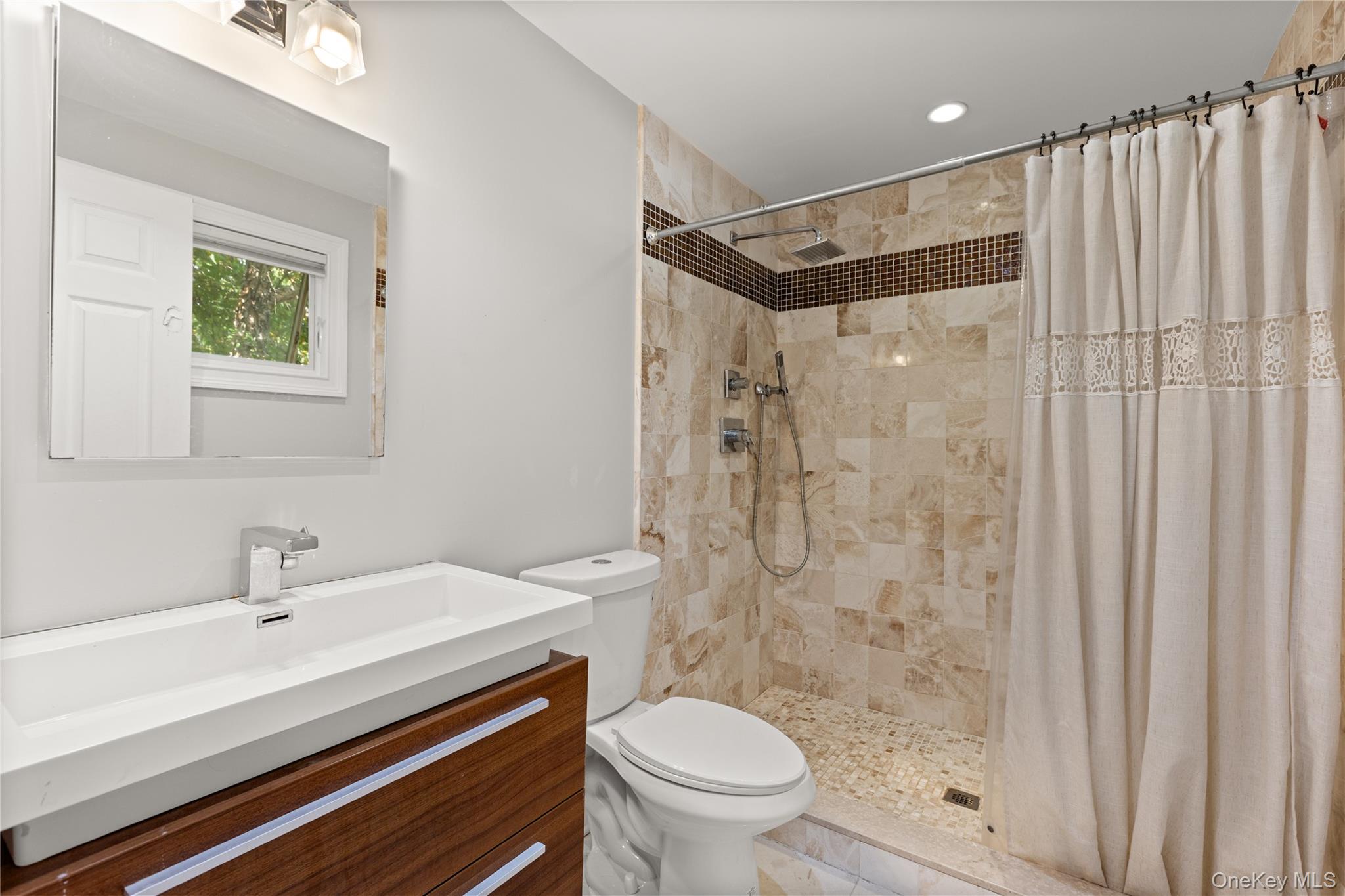 10 Great Cove Lane Islip, NY 11751 - Photo 22 of 31 a bathroom with a sink toilet and shower