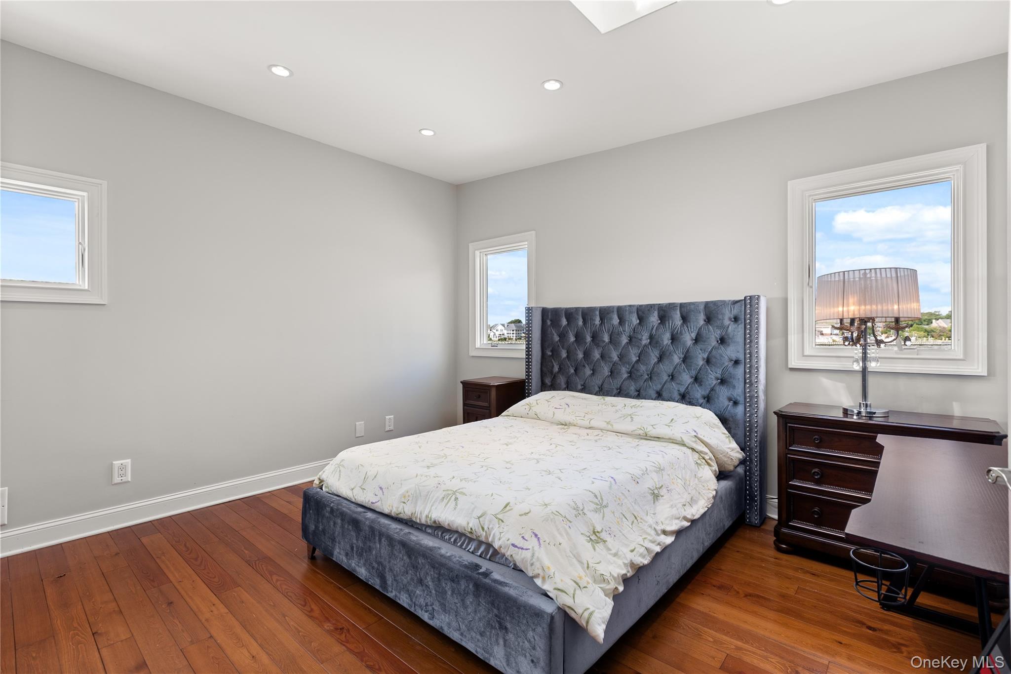 10 Great Cove Lane Islip, NY 11751 - Photo 23 of 31 a bedroom with a bed and dresser with wooden floor